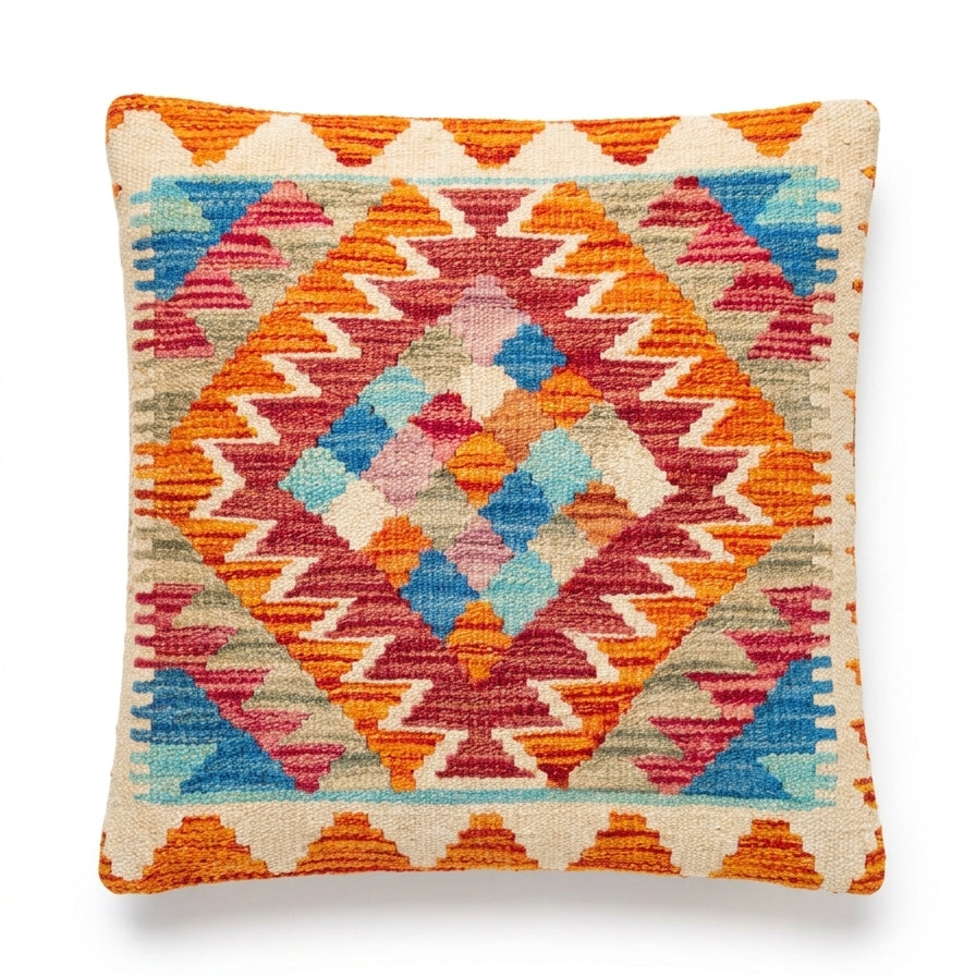 Kilim cushion with geometric pattern in orange, blue, pink, and cream colors, square shape, decorative textile by eastofhere.