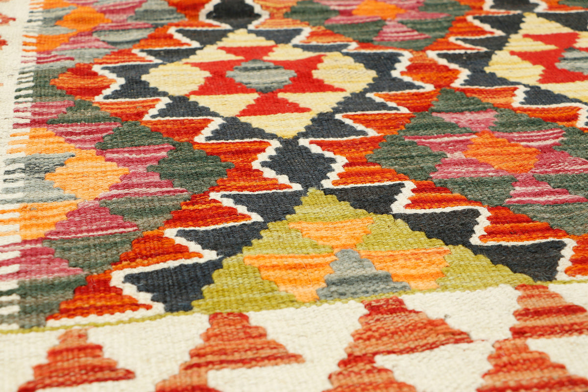 Afghan Kilim rug by eastofhere, 120x80cm, featuring traditional geometric patterns in vibrant colors and woven texture.