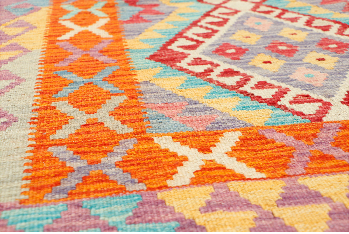 Afghan Kilim rug by eastofhere with geometric patterns in vibrant colors, measuring 123x82cm, displayed on a neutral background.