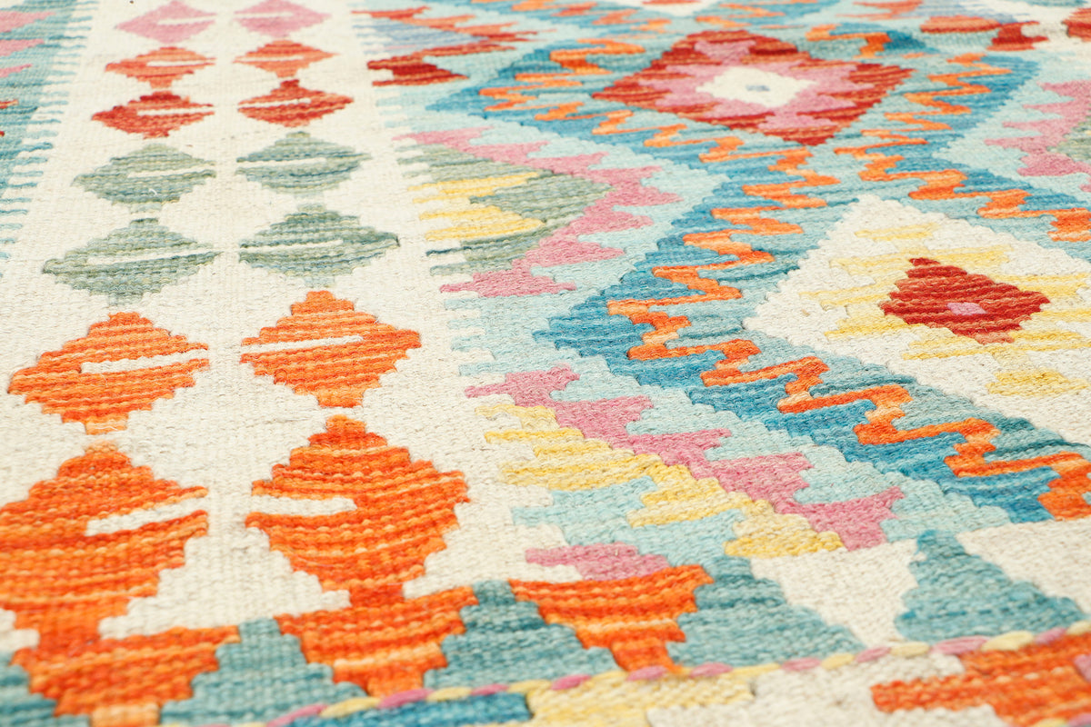 Afghan Kilim rug by eastofhere, 111x90cm, featuring traditional geometric patterns and vibrant colors on woven fabric.