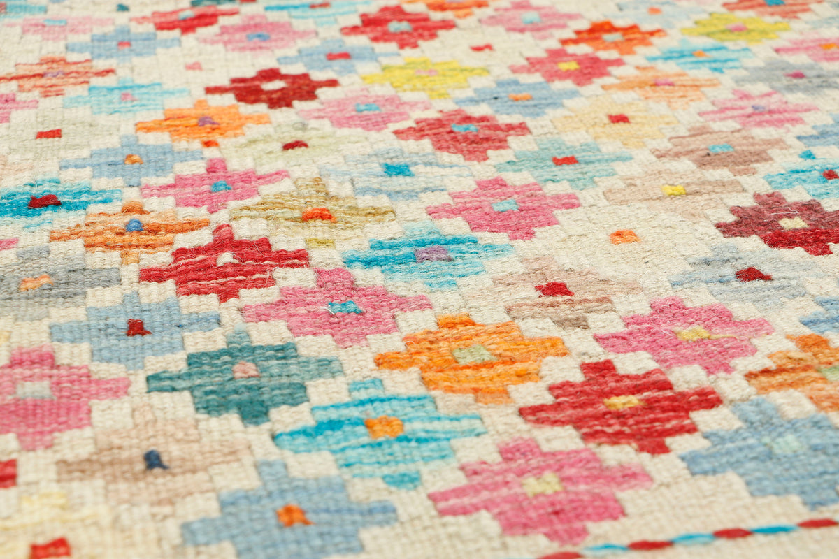 Afghan Kilim rug by eastofhere, 115x83cm, featuring traditional geometric patterns and vibrant colors on woven fabric.