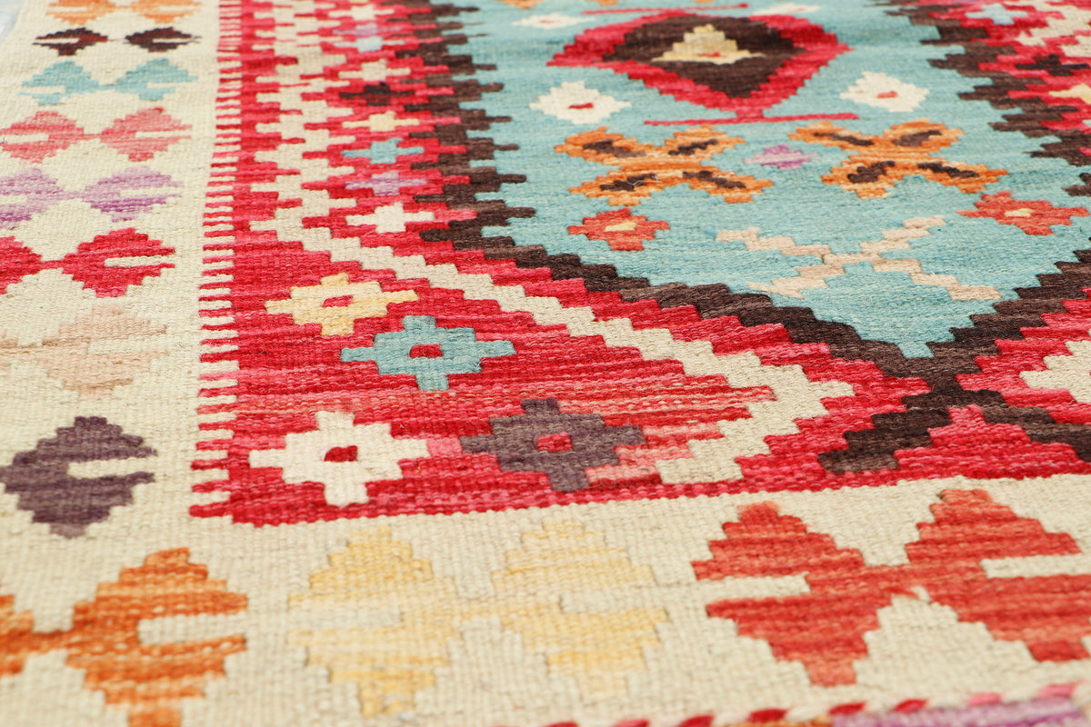 Afghan Kilim rug by eastofhere, 123x78cm, featuring traditional geometric patterns and vibrant colors on woven fabric.