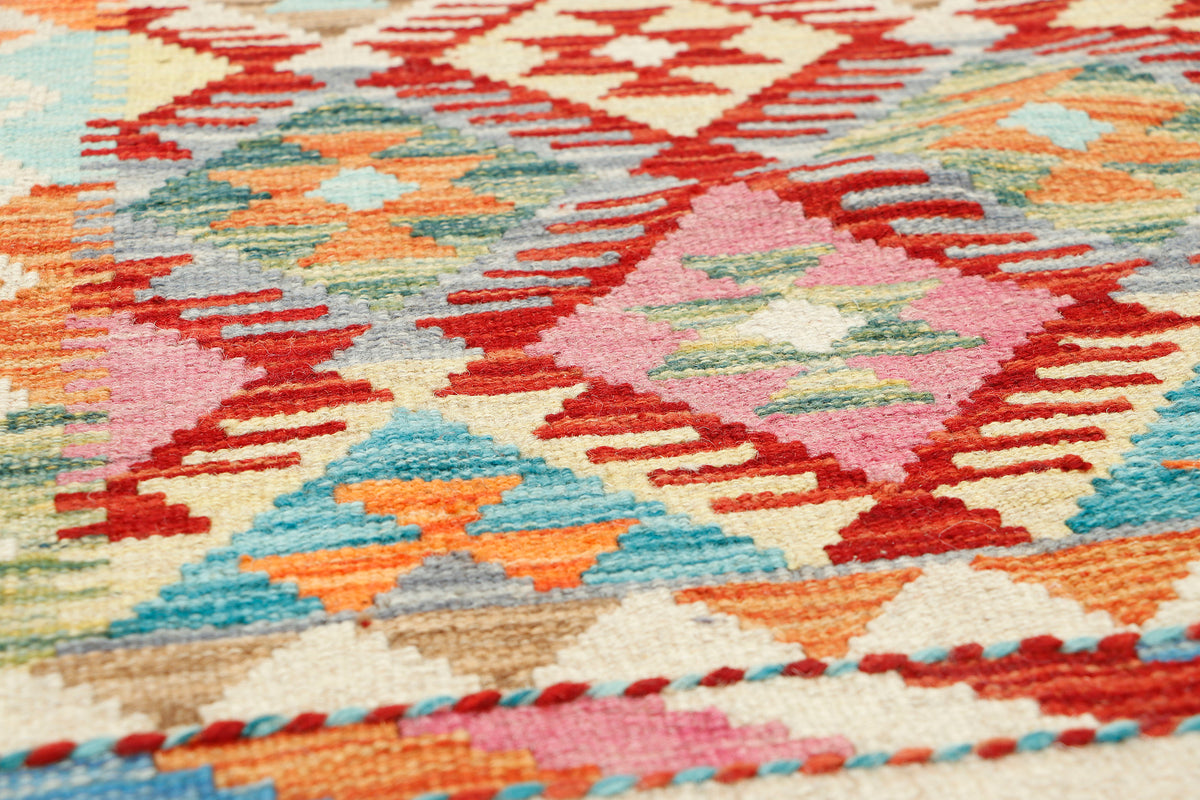 Afghan Kilim rug by eastofhere, 126x80cm, featuring traditional geometric patterns in vibrant colors and woven textile design.