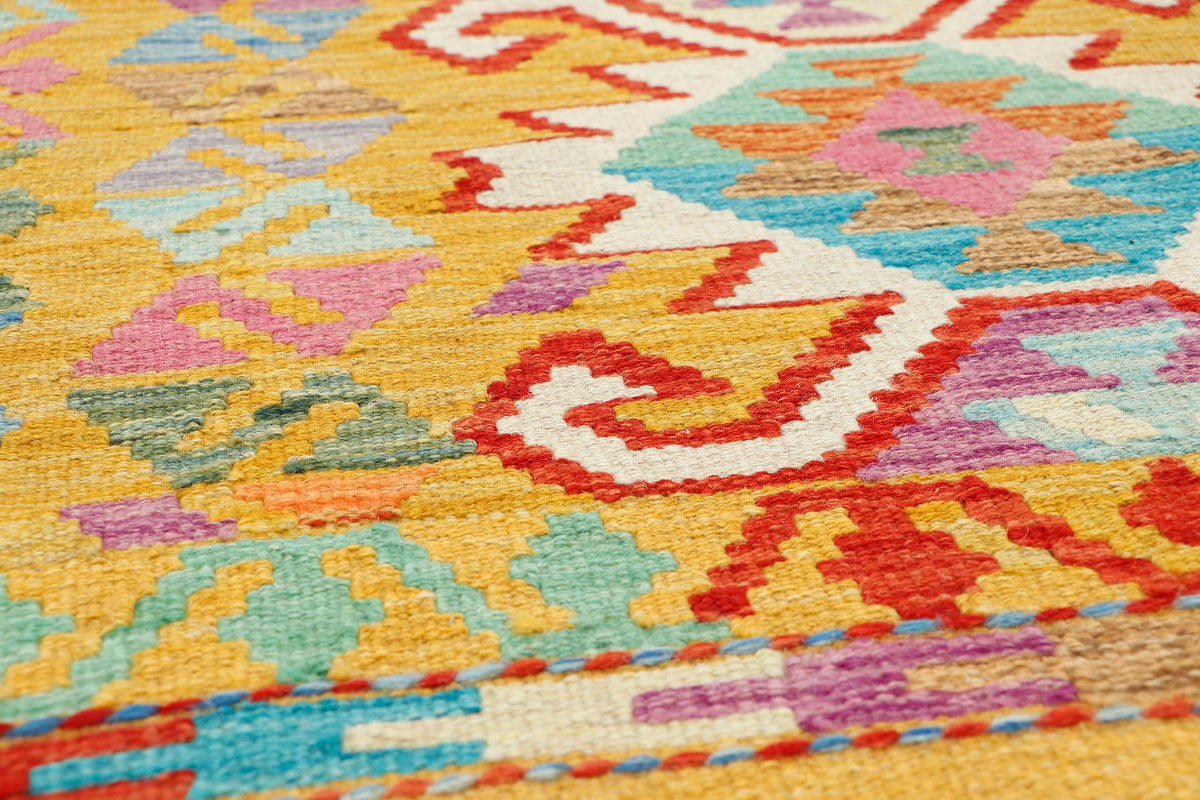 Afghan Kilim rug from eastofhere, 125x88cm, featuring traditional geometric patterns and vibrant colors on woven textile.