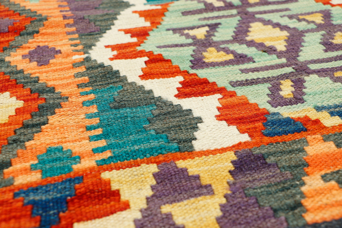 Afghan Kilim runner rug by eastofhere, 189 x 61cm, with traditional geometric patterns and vibrant earthy colors.