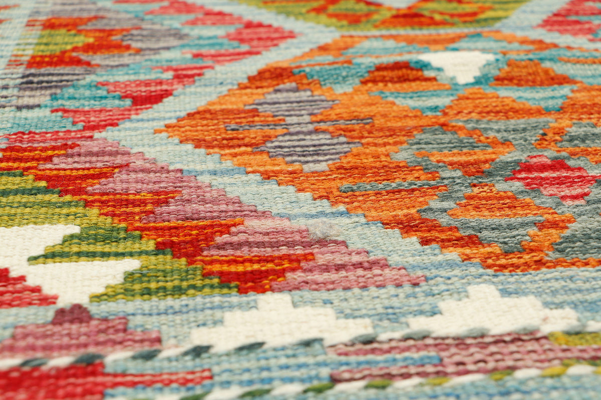 Afghan Kilim runner rug by eastofhere, 150x61cm, featuring traditional geometric patterns in vibrant colors.