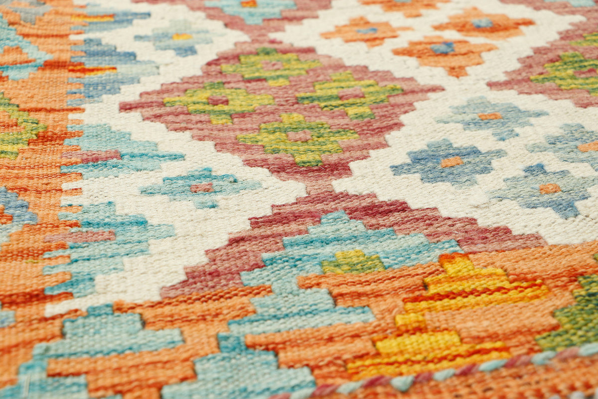 Afghan Kilim runner rug by eastofhere, 145x57cm, featuring traditional geometric patterns in vibrant colors on woven fabric.
