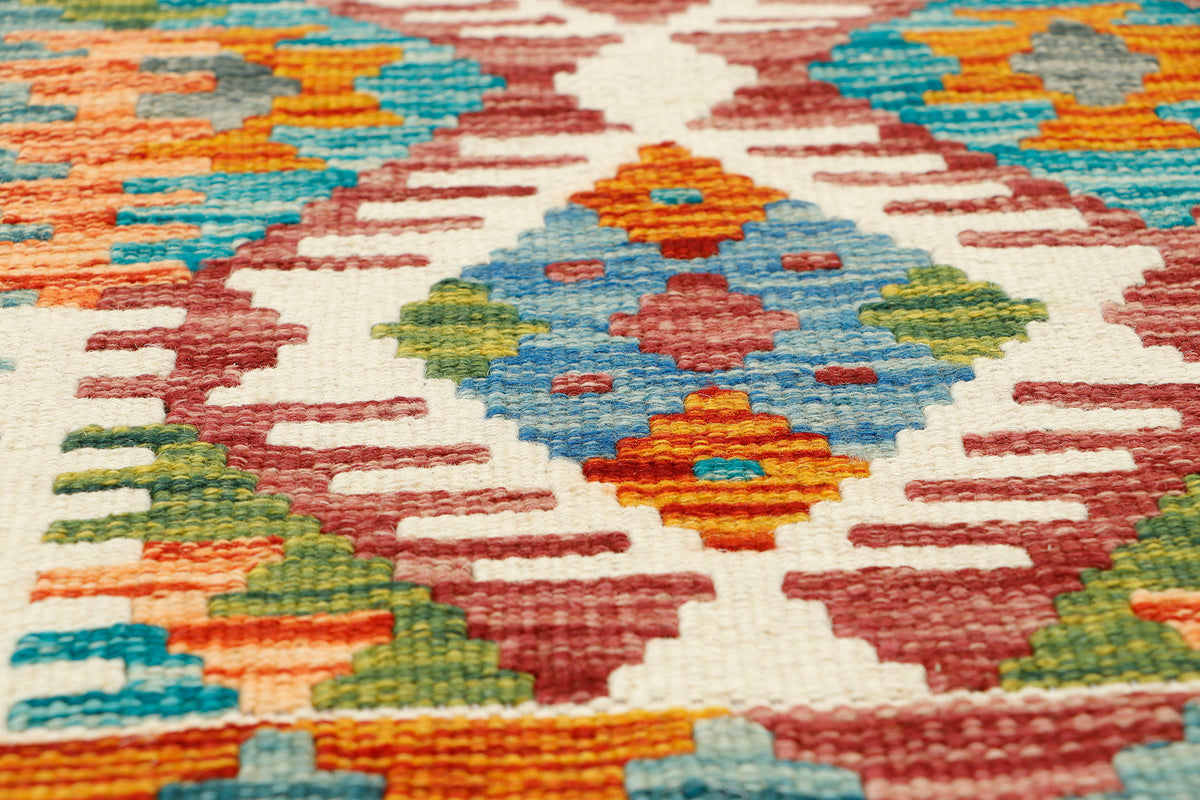 Afghan Kilim runner rug by eastofhere, 141x63cm, featuring traditional geometric patterns and vibrant colors on a woven textile.