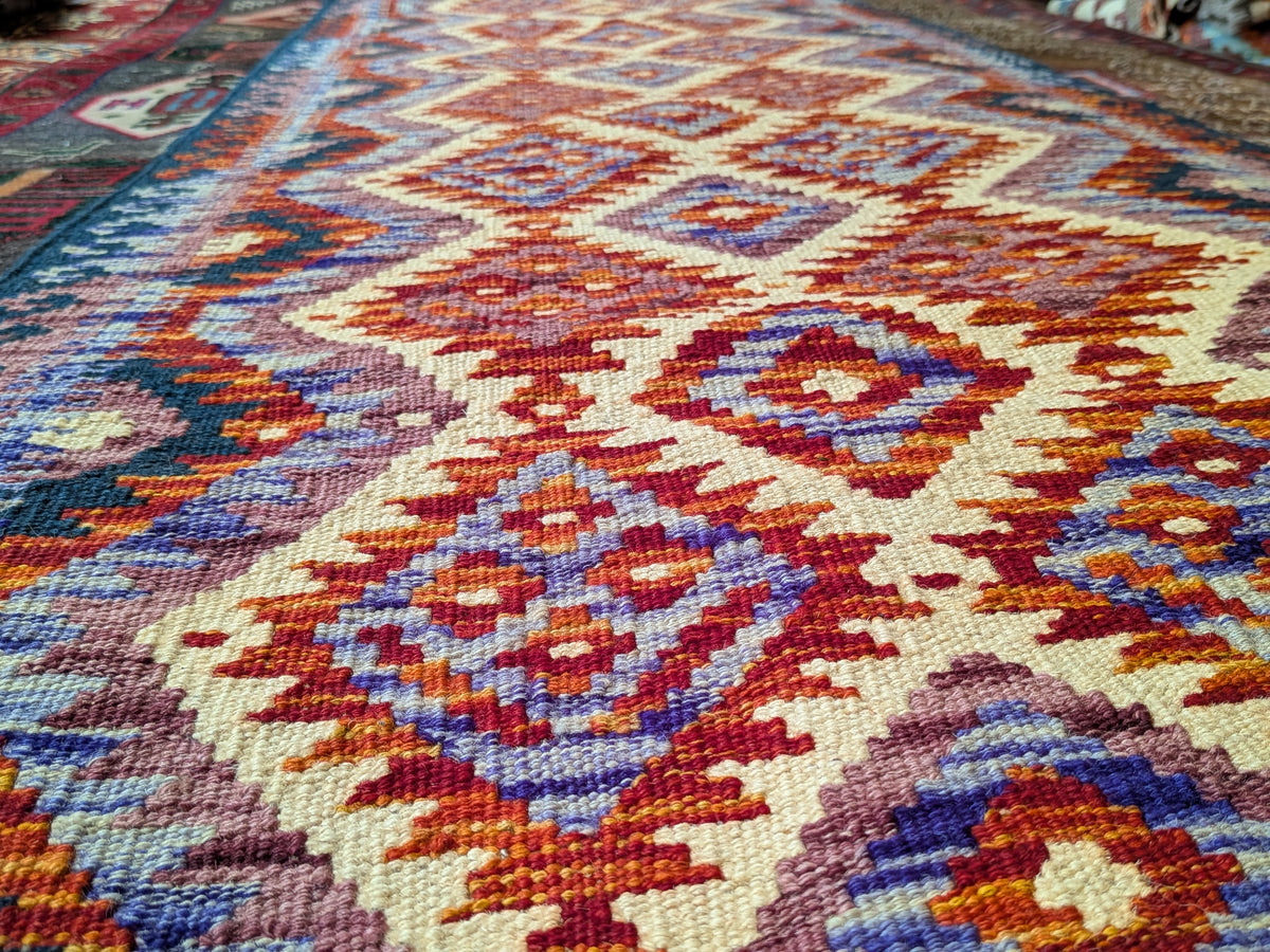 Eastofhere Kilim runner rug, 207 x 75cm, featuring traditional geometric patterns in warm earthy tones on a woven surface.