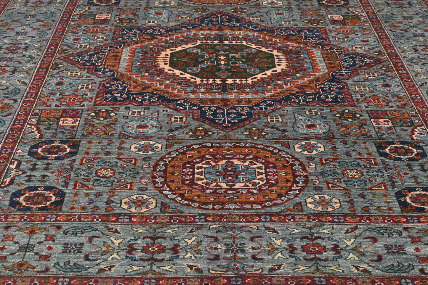 Close-up of a patterned rug with geometric designs.