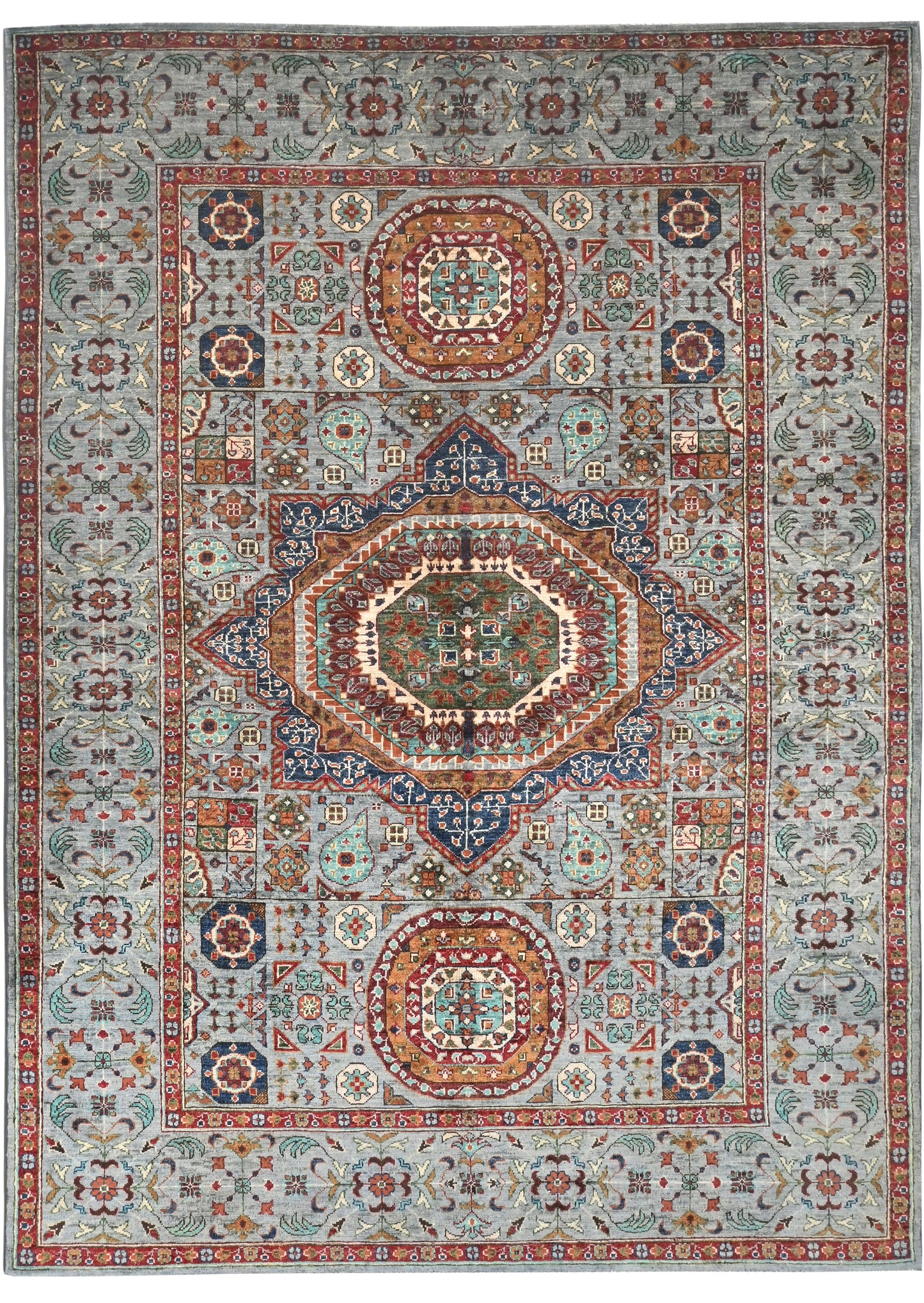 Decorative rug with intricate patterns and colors on a white background