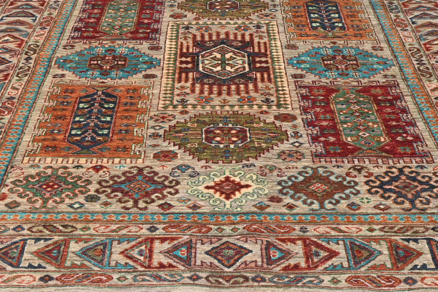 Close-up of a patterned rug with geometric designs in various colors.