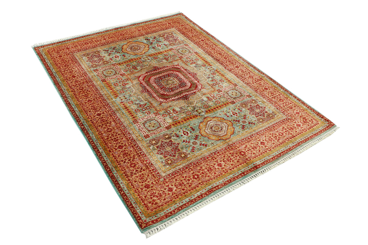 An oriental-style area rug with a traditional geometric and floral pattern, featuring a central medallion, multiple borders, and white fringe on the ends, shown from an elevated angle on a white background.
