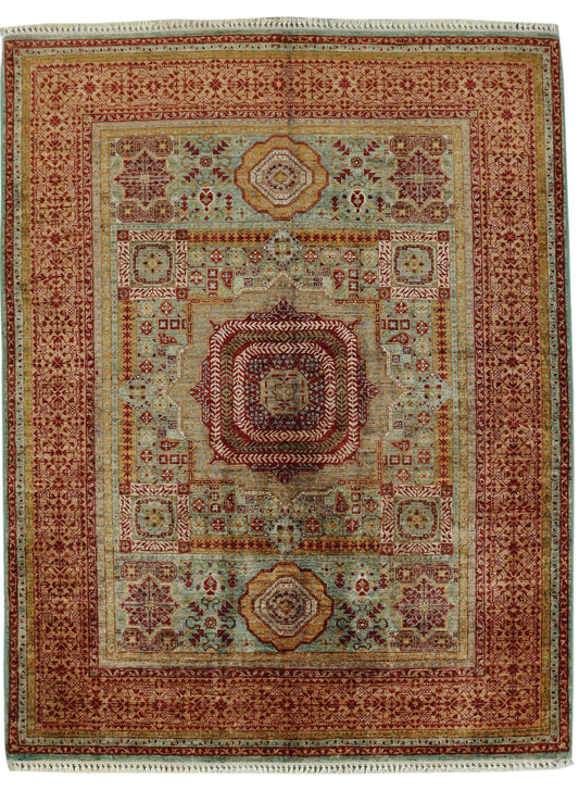 A traditional oriental area rug with a complex geometric and floral pattern, featuring a central medallion, multiple borders, and fringed edges.
