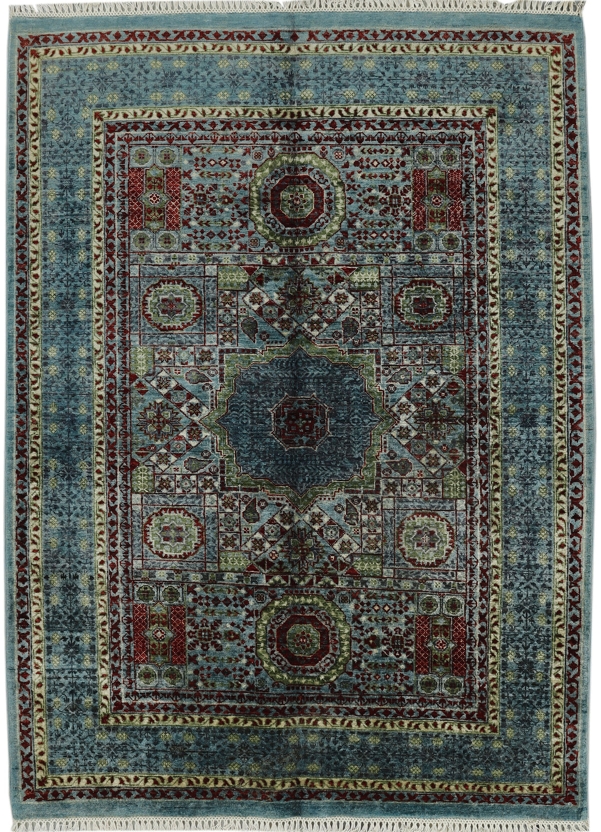 A traditional oriental area rug with a complex geometric and floral pattern, featuring a dusty blue field, a central medallion, and a wide decorative border in muted red, green, and beige tones.