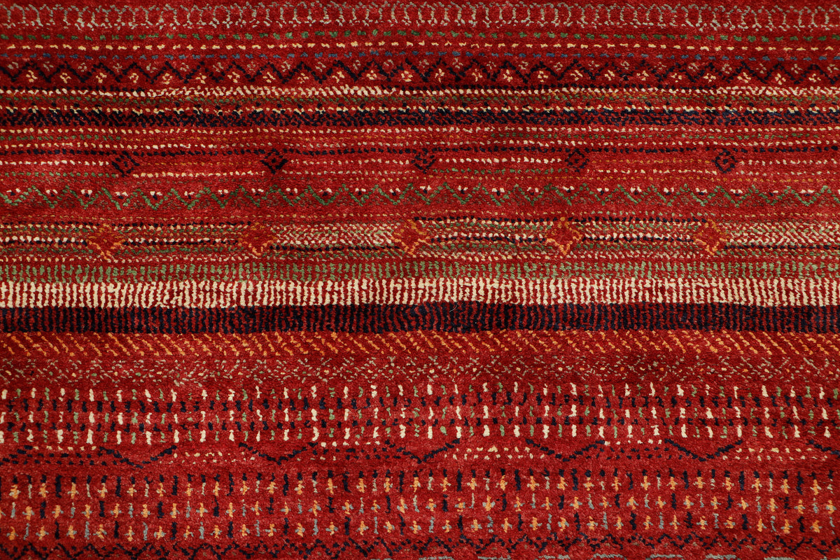 Afghan Gabbeh rug by eastofhere, measuring 253x173cm, showcasing bold geometric motifs and warm earthy tones.