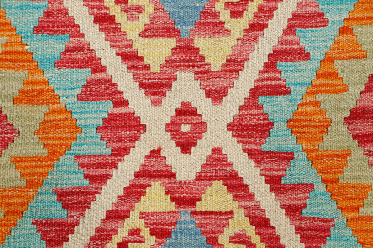 Afghan Kilim rug by eastofhere, 116x76cm, featuring traditional geometric patterns in vibrant colors on woven fabric.