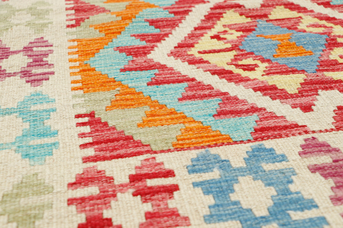 Afghan Kilim rug by eastofhere featuring colorful geometric patterns, measuring 116x76cm, showcasing traditional handcrafted design.