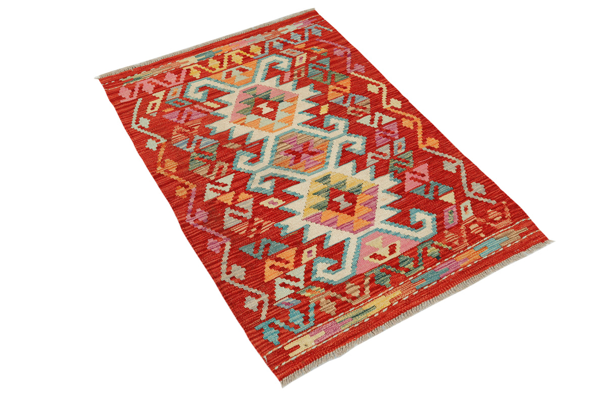 Afghan Kilim rug by eastofhere featuring geometric patterns in vibrant colors, measuring 118x82cm, displayed on a wooden floor.