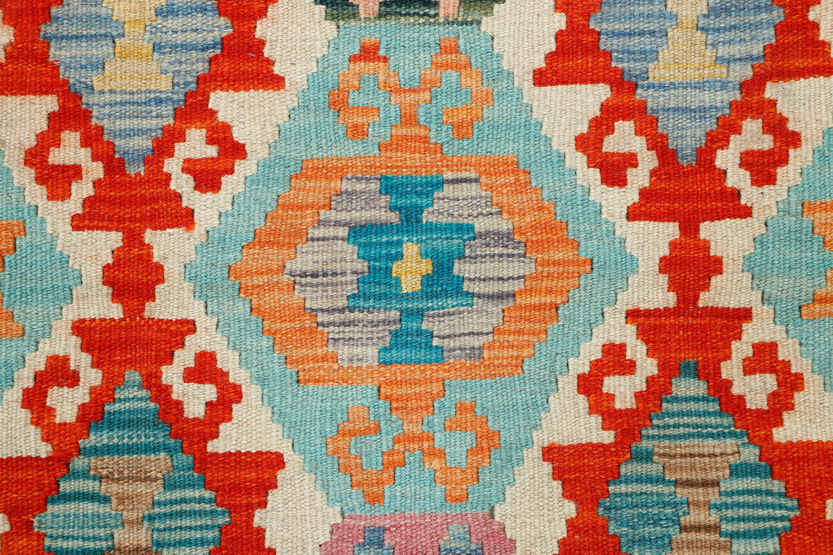 Colorful Afghan Kilim rug by eastofhere, featuring traditional geometric patterns, measuring 127x81cm, with intricate woven details.