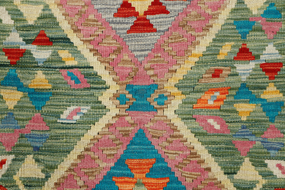 Afghan Kilim rug by eastofhere, 119x79cm, featuring traditional geometric patterns and vibrant colors on woven textile.