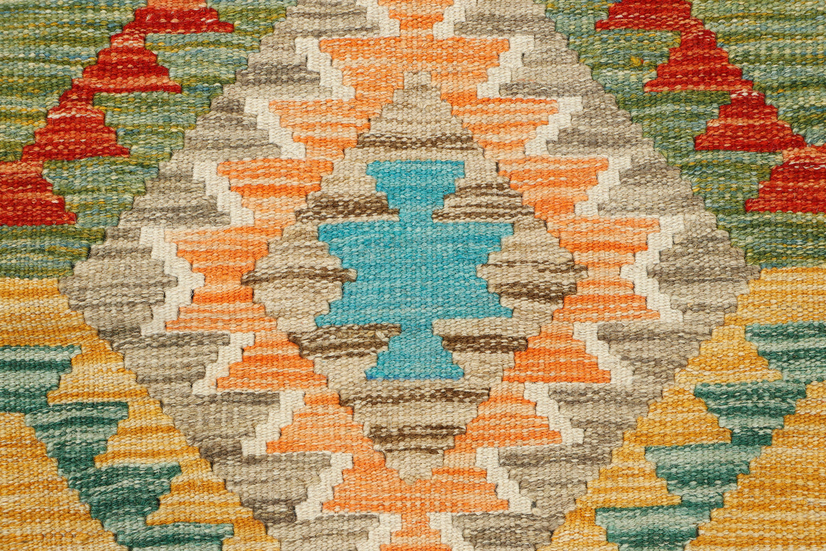 Afghan Kilim rug by eastofhere, 131 x 90cm, featuring traditional geometric patterns and vibrant colors on woven fabric.