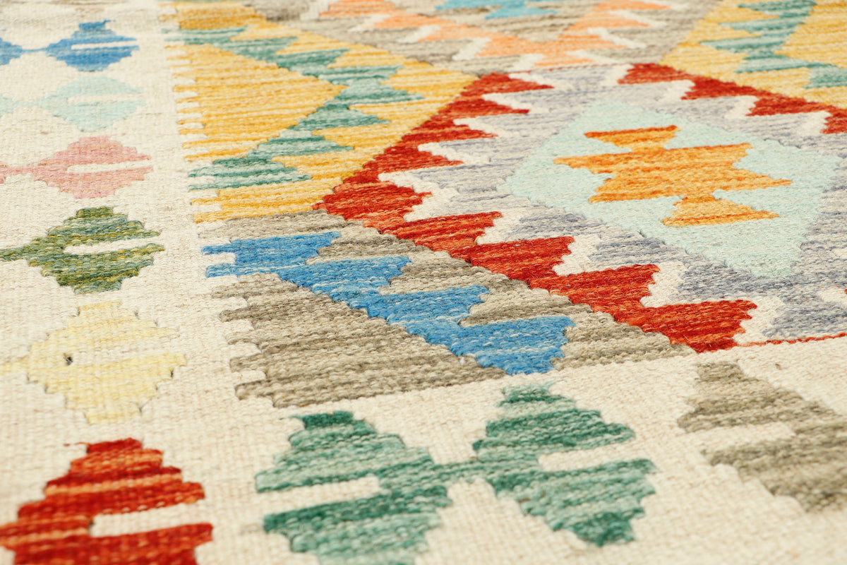 Afghan Kilim rug by eastofhere with geometric patterns, 131x90cm, featuring vibrant colors and traditional woven design.