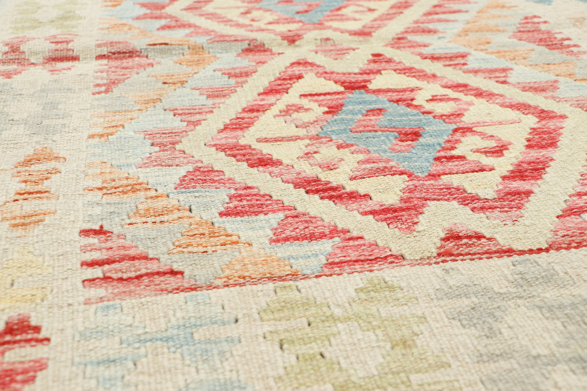 Afghan Kilim rug by eastofhere, 110x75cm, featuring traditional geometric patterns and vibrant colors on woven textile.