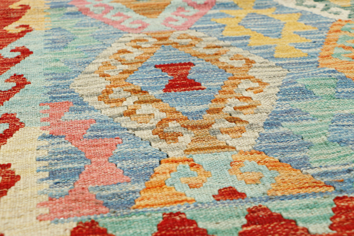 Afghan Kilim rug by eastofhere with geometric patterns, measuring 115x78cm, showcasing vibrant colors and traditional woven design.