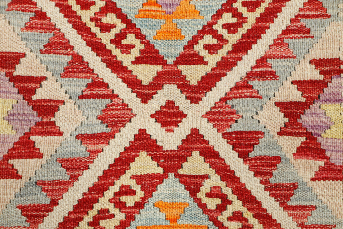Afghan Kilim rug from eastofhere, 111x75cm, with traditional geometric patterns and vibrant colors, showing intricate woven details.