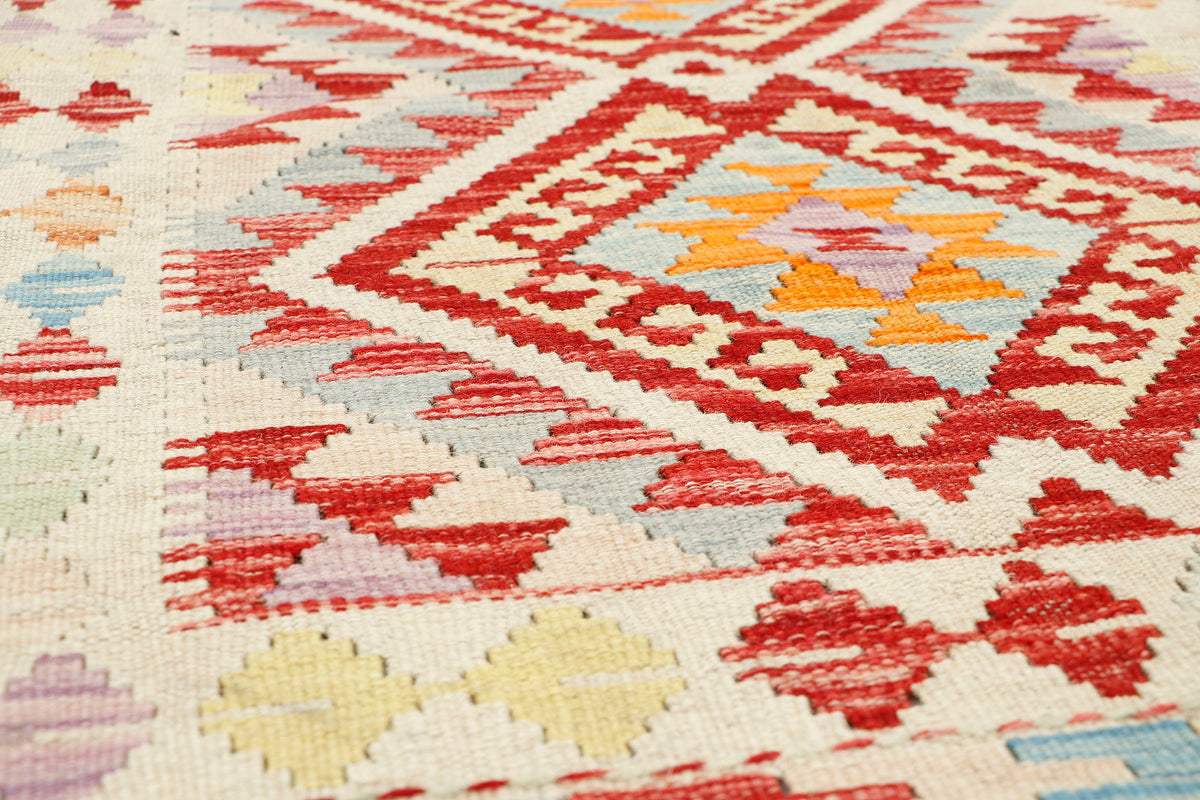 Afghan Kilim rug by eastofhere, 111x75cm, featuring traditional geometric patterns and vibrant colors on a woven textile background.
