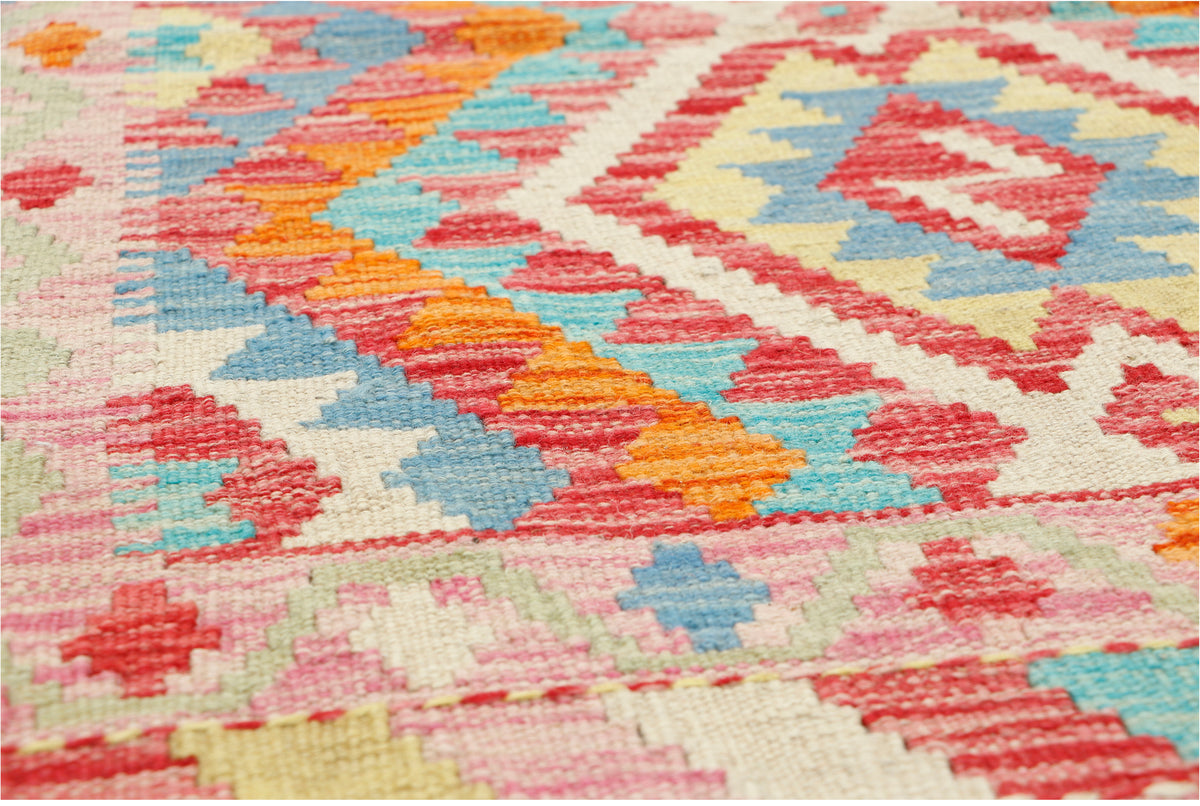 Afghan Kilim rug by eastofhere, 110x80cm, featuring traditional geometric patterns and vibrant colors on woven textile.