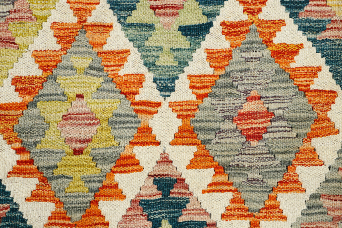 Afghan Kilim rug by eastofhere featuring vibrant geometric patterns in warm earthy tones, measuring 148x87cm.