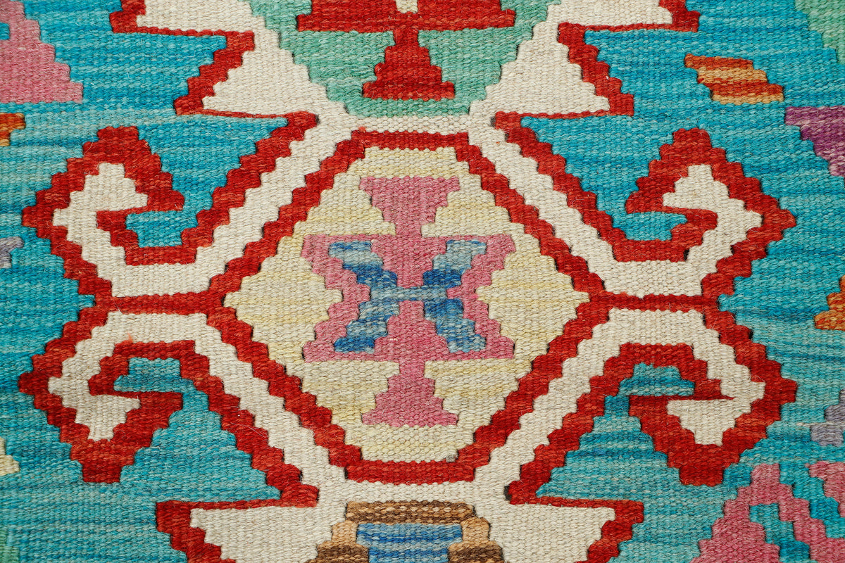 Afghan Kilim rug by eastofhere, 123x88cm, featuring traditional geometric patterns and vibrant colors on a woven fabric background.