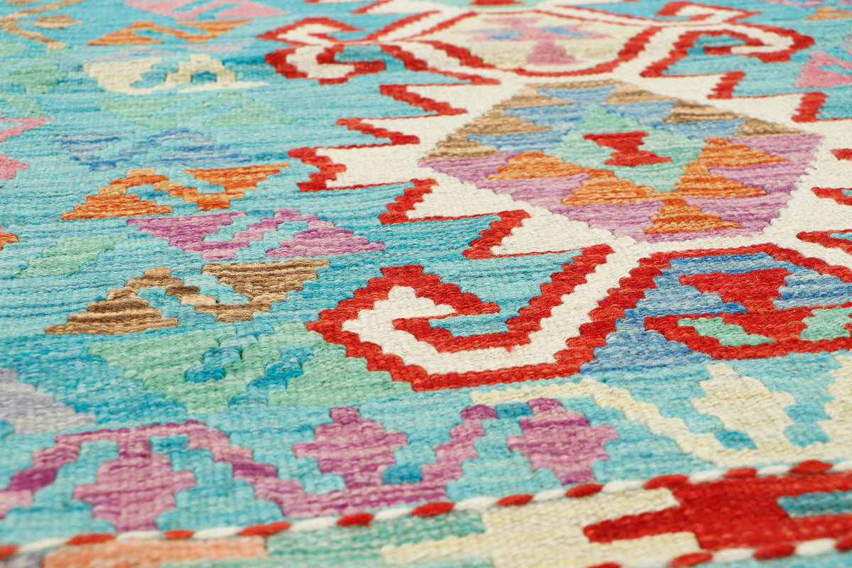 Afghan Kilim rug by eastofhere featuring traditional geometric patterns in vibrant colors, measuring 123x88cm.