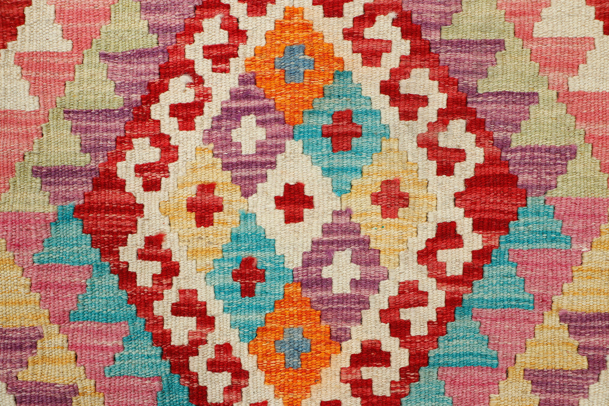 Afghan Kilim rug by eastofhere, 121x83cm, featuring traditional geometric patterns and vibrant colors on woven textile.