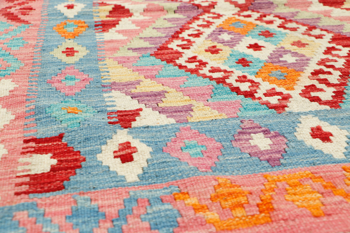 Afghan Kilim rug by eastofhere featuring vibrant geometric patterns in warm earthy tones, measuring 121x83cm.
