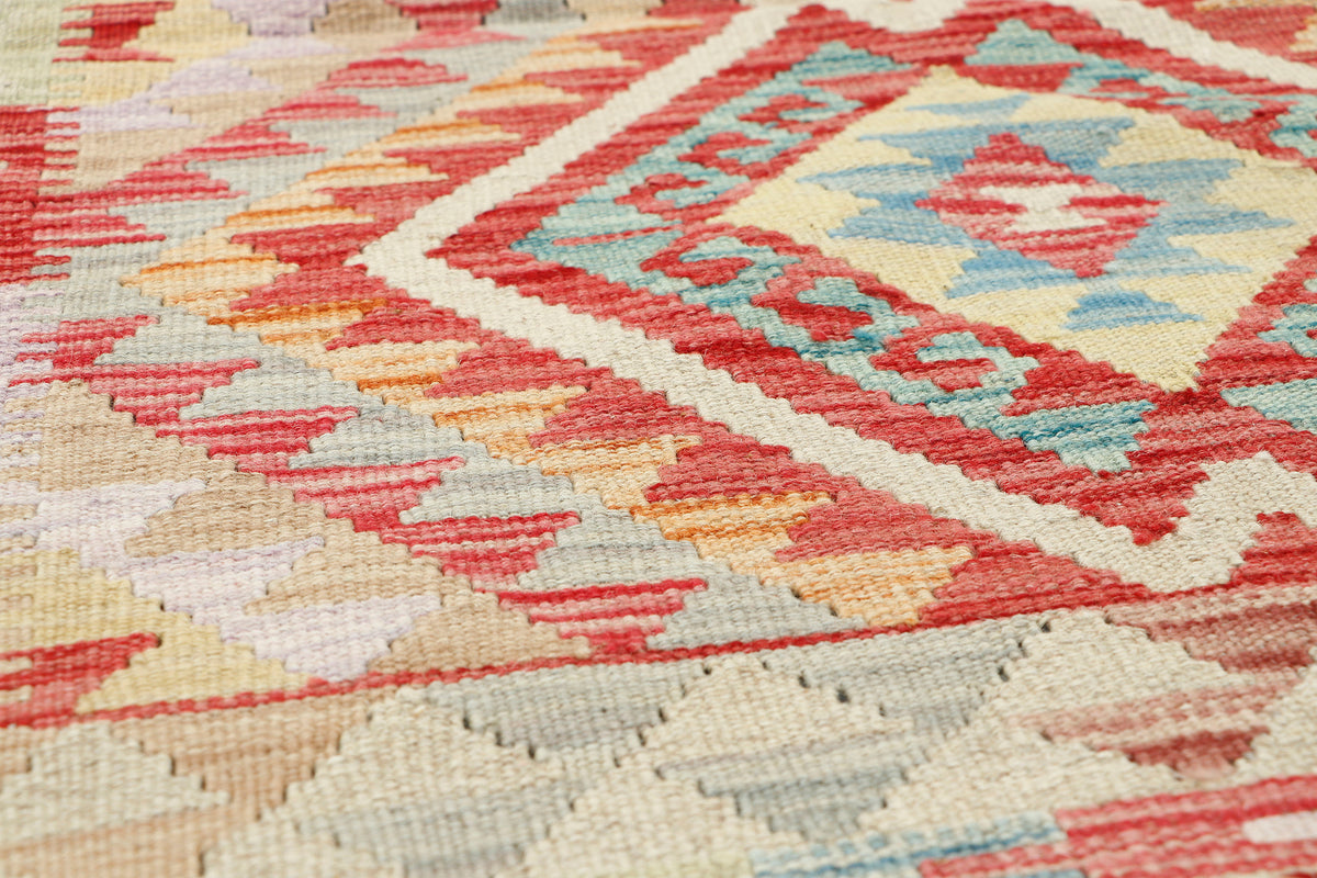 Afghan Kilim rug by eastofhere, 112x75cm, featuring traditional geometric patterns in vibrant colors on woven textile.
