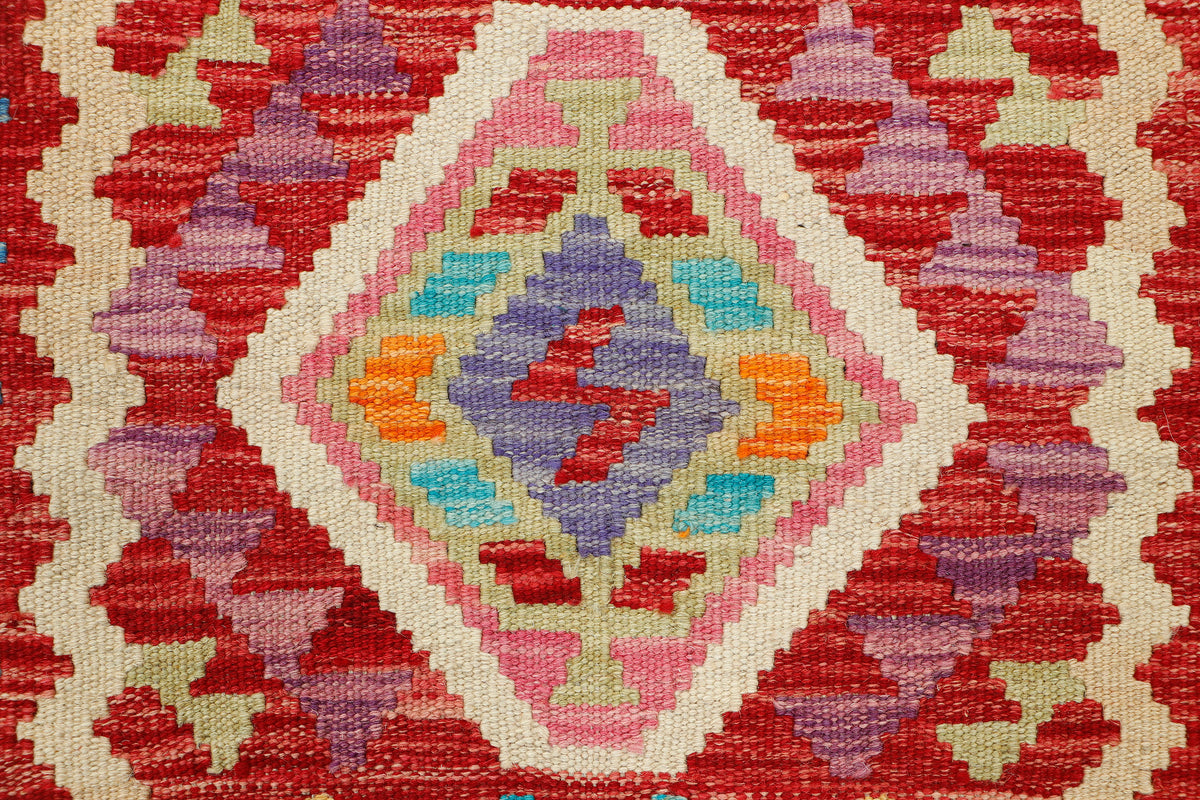 Afghan Kilim rug by eastofhere, 106x84cm, featuring traditional geometric patterns and vibrant colors on woven fabric.