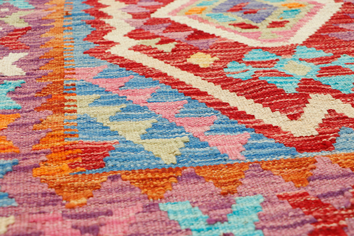 Afghan Kilim rug by eastofhere, 106x84cm, featuring traditional geometric patterns and vibrant colors in a woven textile design.