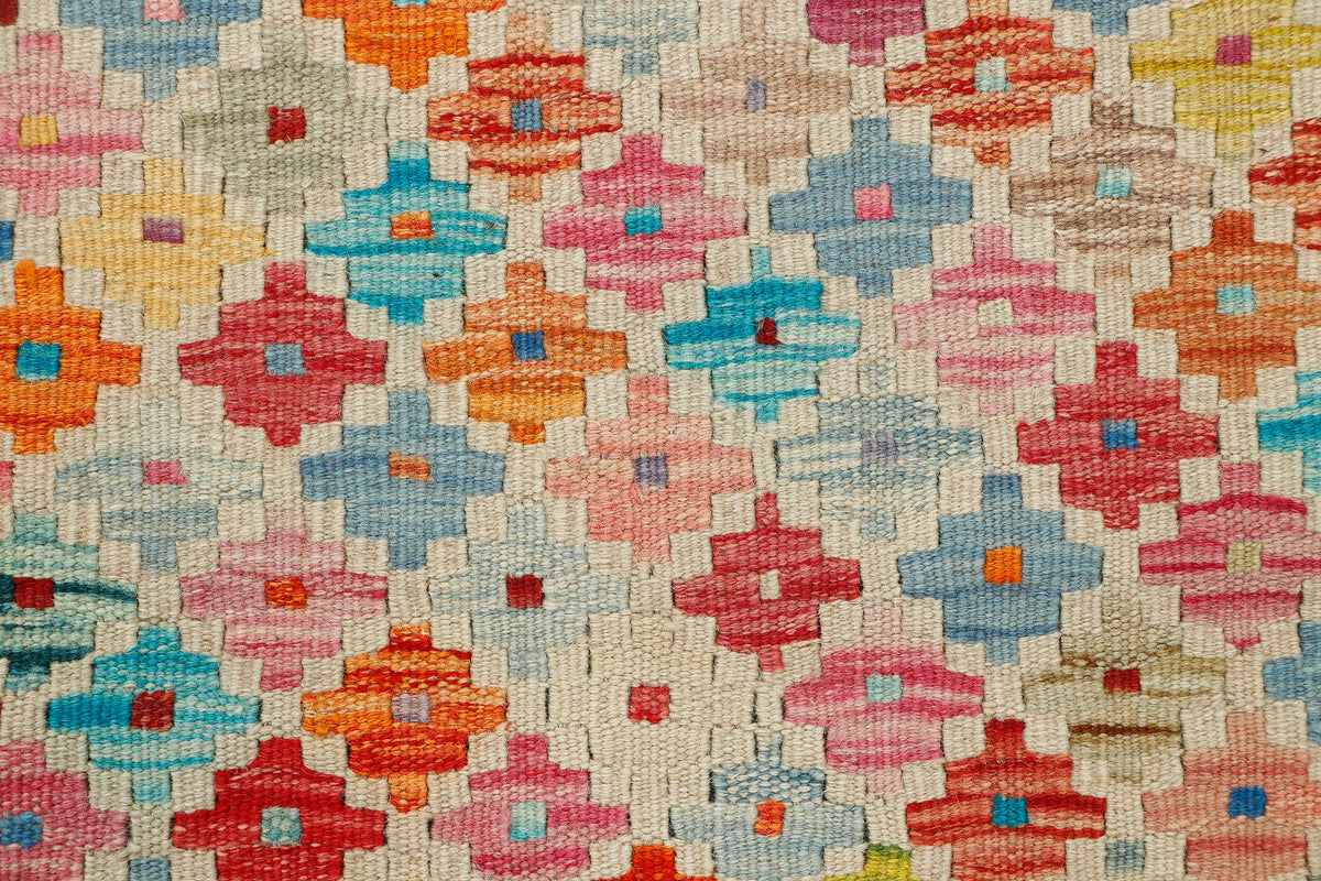 Afghan Kilim rug by eastofhere featuring colorful geometric patterns, measuring 115 x 83cm, displayed on a neutral background.