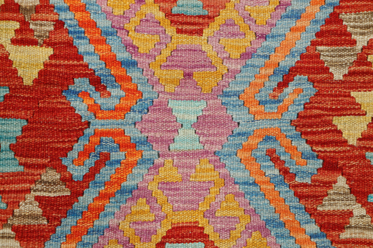 Afghan Kilim rug by eastofhere, 124x77cm, featuring traditional geometric patterns in vibrant colors on a woven textile background.