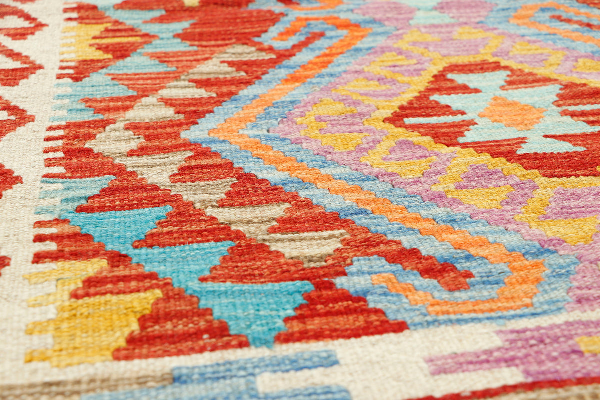 Afghan Kilim rug by eastofhere, 124x77cm, featuring traditional geometric patterns in vibrant colors, handmade textile floor covering.