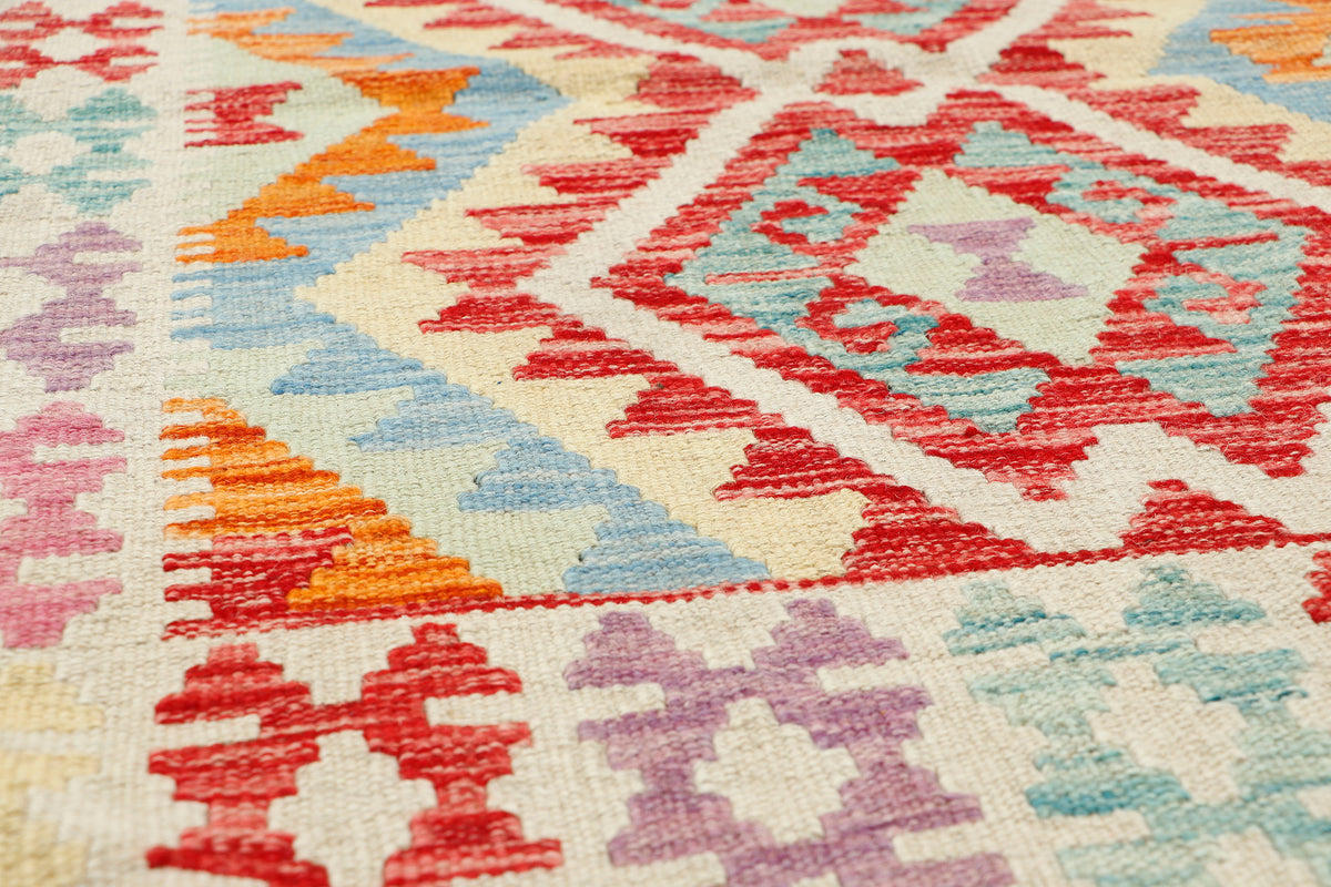 Afghan Kilim rug by eastofhere, 108x78cm, featuring traditional geometric patterns in vibrant colors on woven fabric.