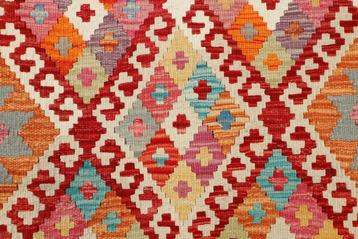 Afghan Kilim rug from eastofhere, 124x88cm, featuring traditional geometric patterns in vibrant colors on a woven textile.