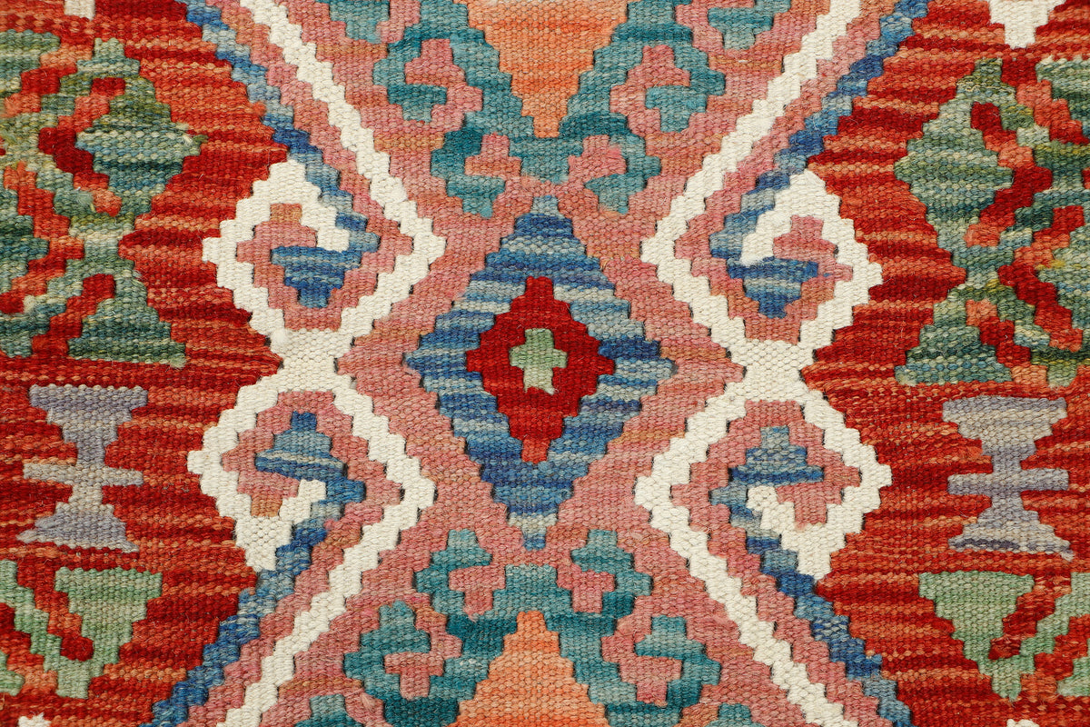 Afghan Kilim rug by eastofhere, 125x85cm, showcasing vibrant geometric patterns and traditional handwoven textile details.