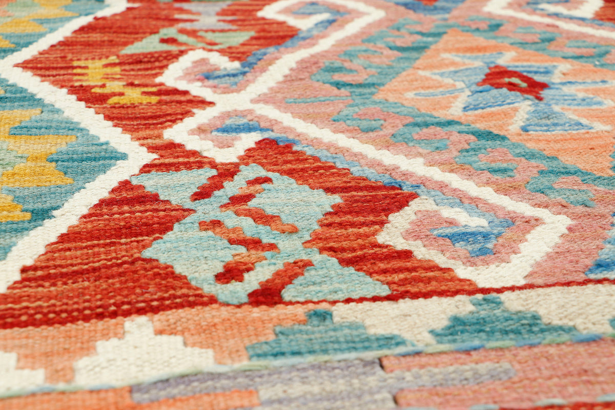 Afghan Kilim rug by eastofhere, 125x85cm, featuring traditional geometric patterns in vibrant colors on a woven textile background.