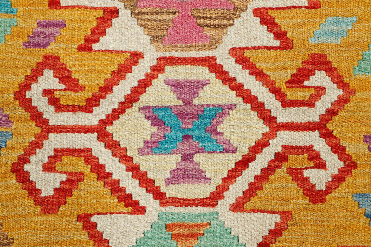 Afghan Kilim rug by eastofhere, 125x88cm, featuring traditional geometric patterns and vibrant colors on woven textile.