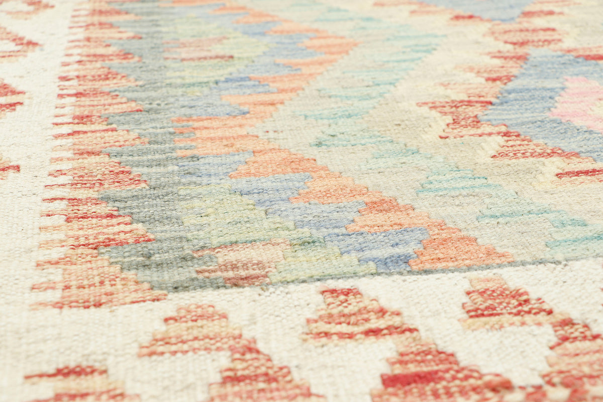 Afghan Kilim rug from eastofhere, 120x87cm, featuring traditional geometric patterns in vibrant colors on woven fabric.