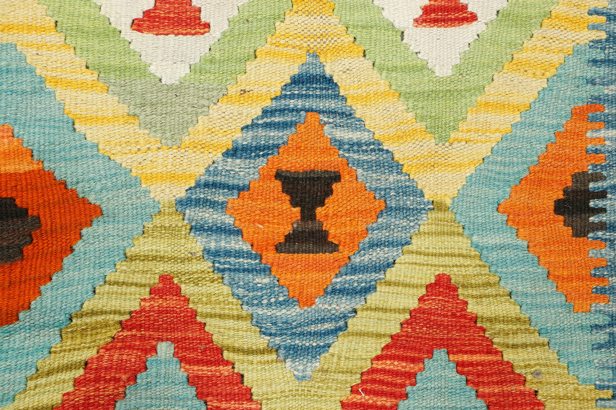 Afghan Kilim rug by eastofhere featuring vibrant geometric patterns in earthy tones, measuring 116x92cm.